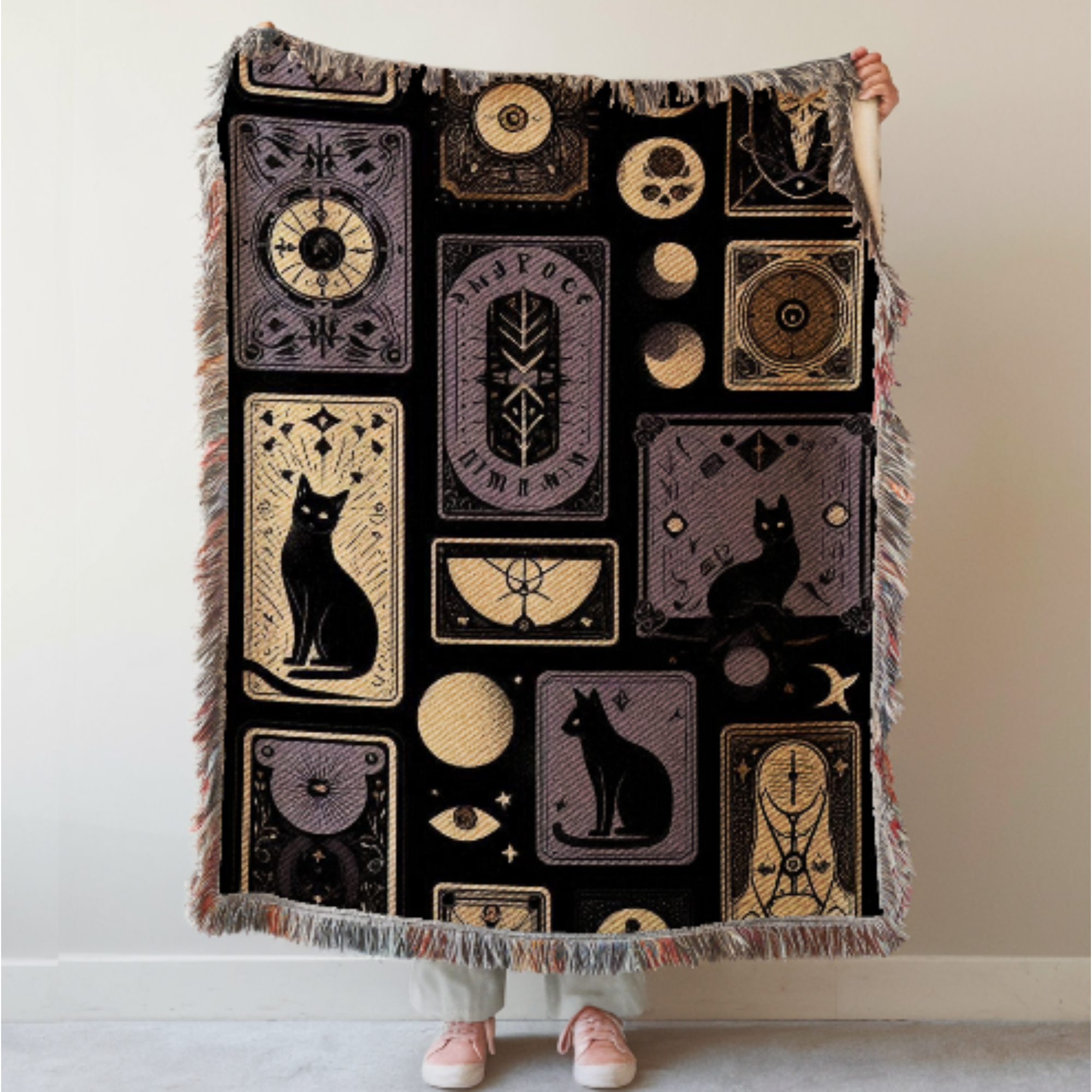 Black Cat Gothic Woven Blanket held by a person against a beige wall.