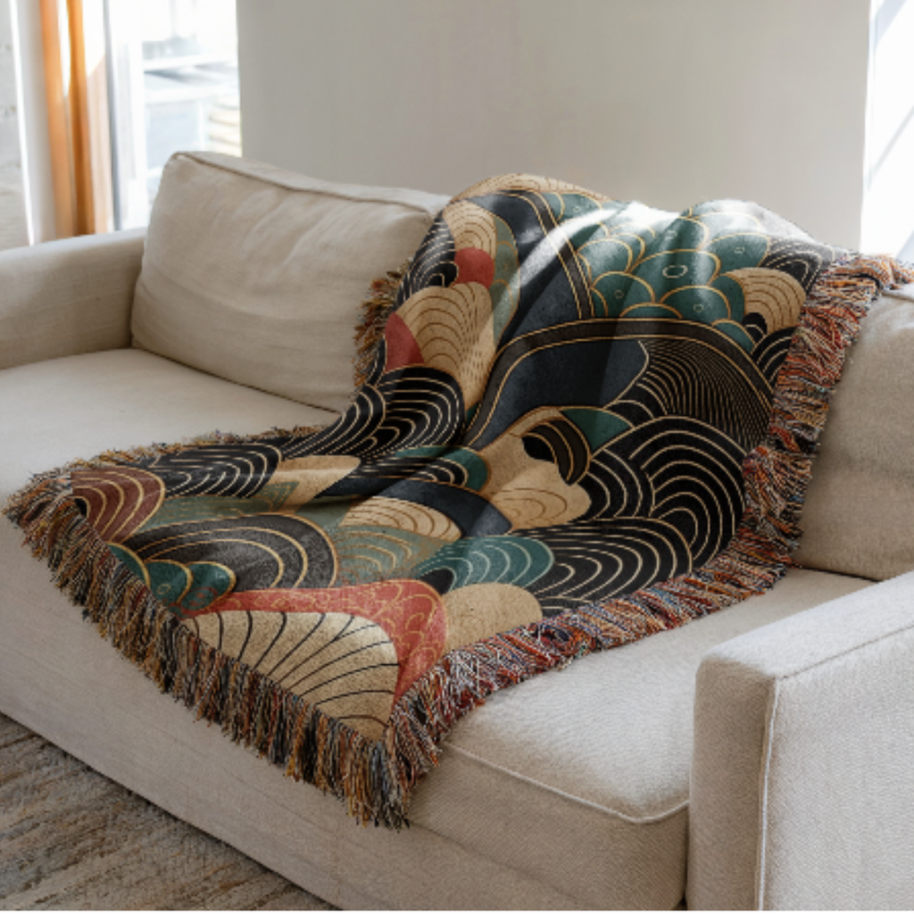 Decorative Japanese inspired woven blanket with geometric pattern draped over a beige sofa in a living room.