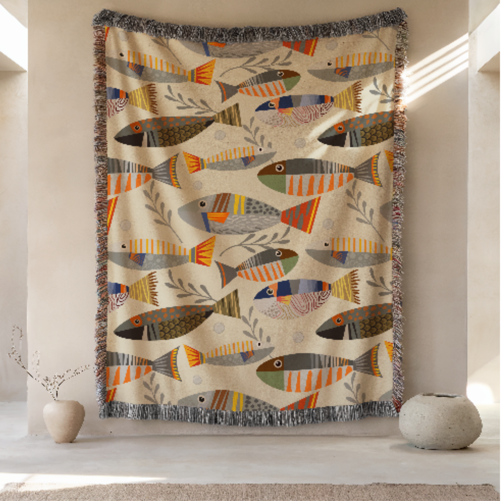 Decorative woven tapestry blanket with fish pattern hanging on a wall